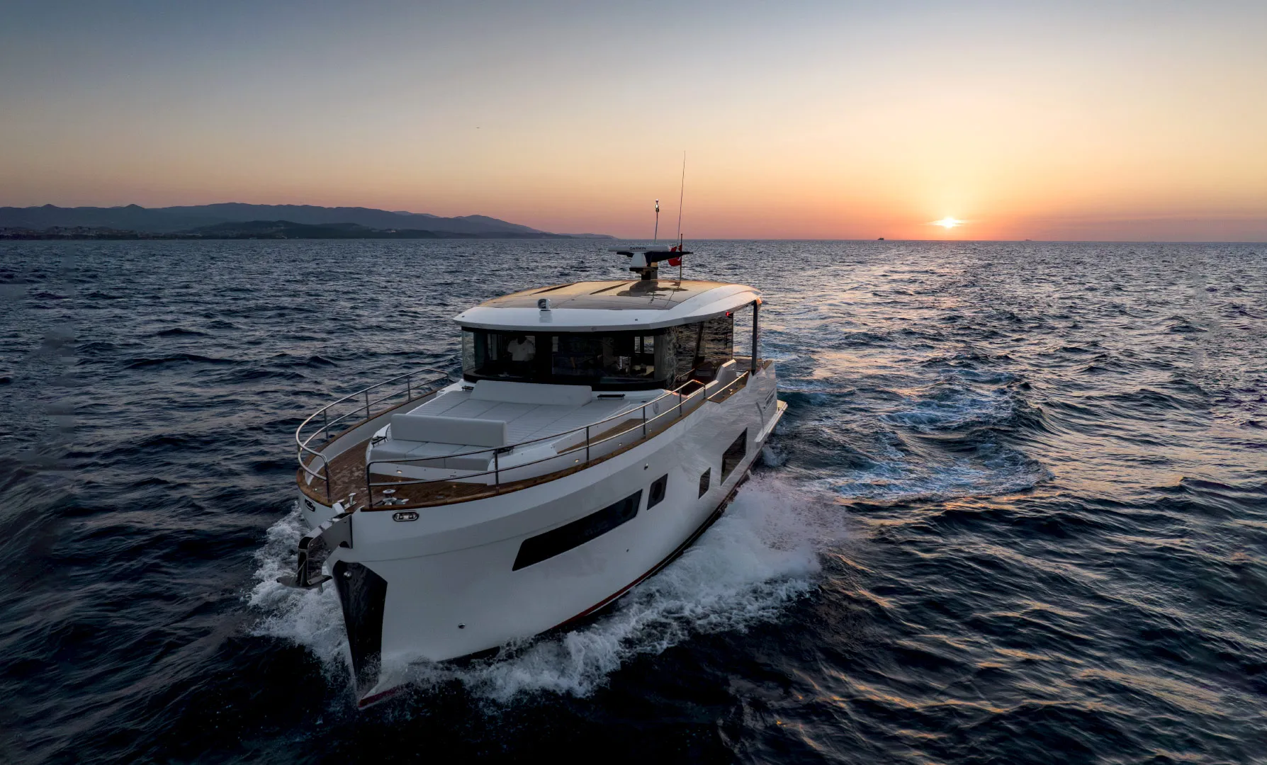Sirena 48 Coupe cruising at sunset, aerial view