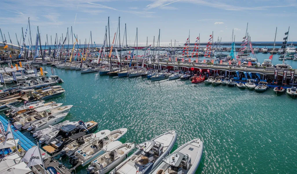 An aerial view of the 2024 Fair Rally showcasing a marina filled with luxury yachts and exhibition stands.
