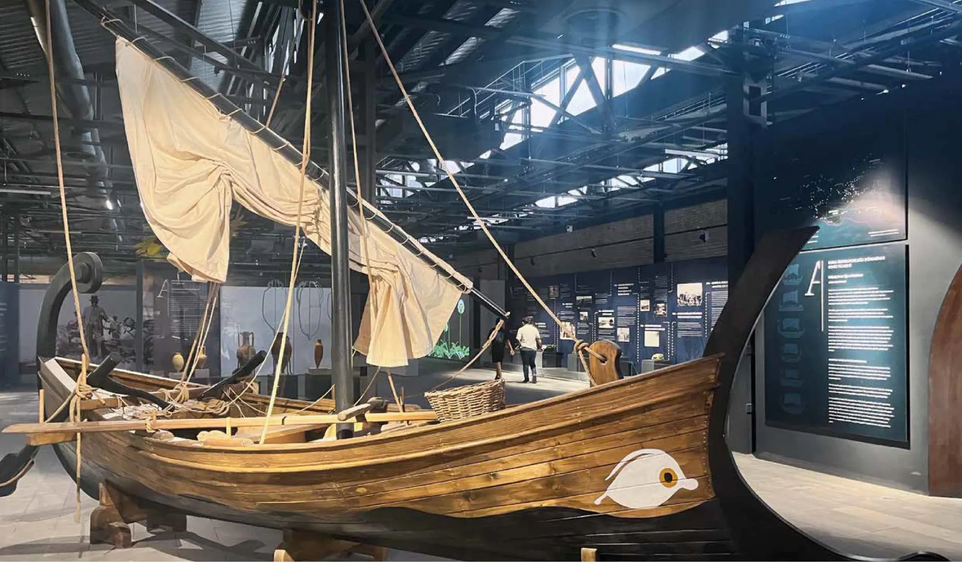 The interior of Adana Museum showcasing a wooden boat replica, highlighting traces of maritime trade history.