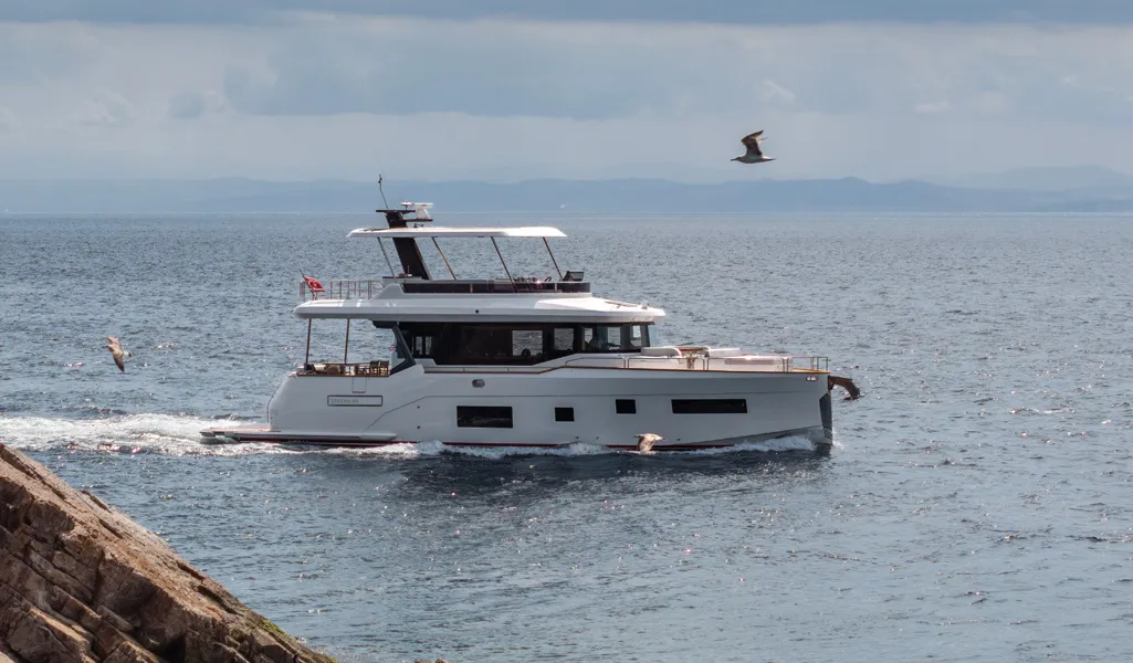 Sirena 60 cruising past a rocky coastline
