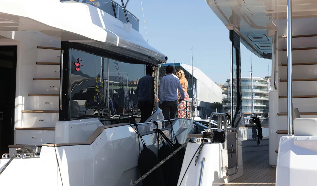 Visitors on the side deck of a Sirena yacht at the Genoa Boat Show